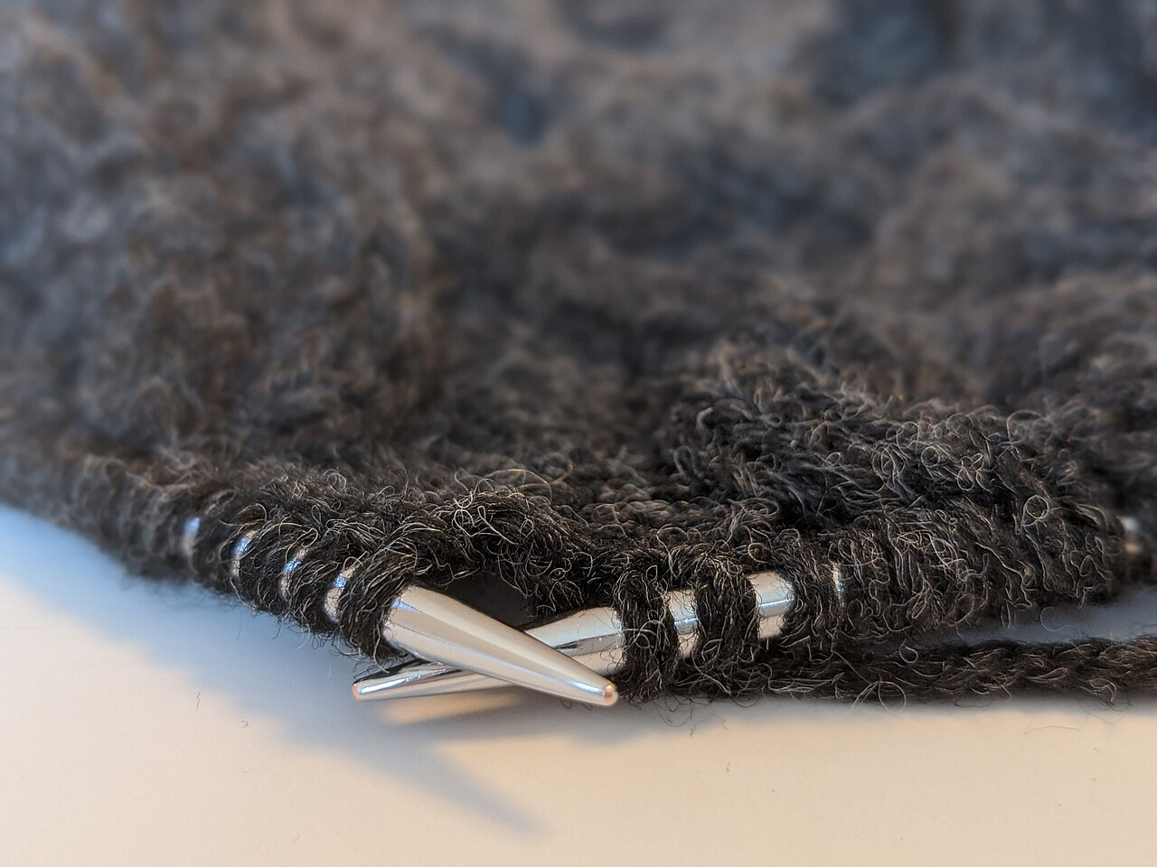 Knitting needles with yarn arranged for a gauge swatch
