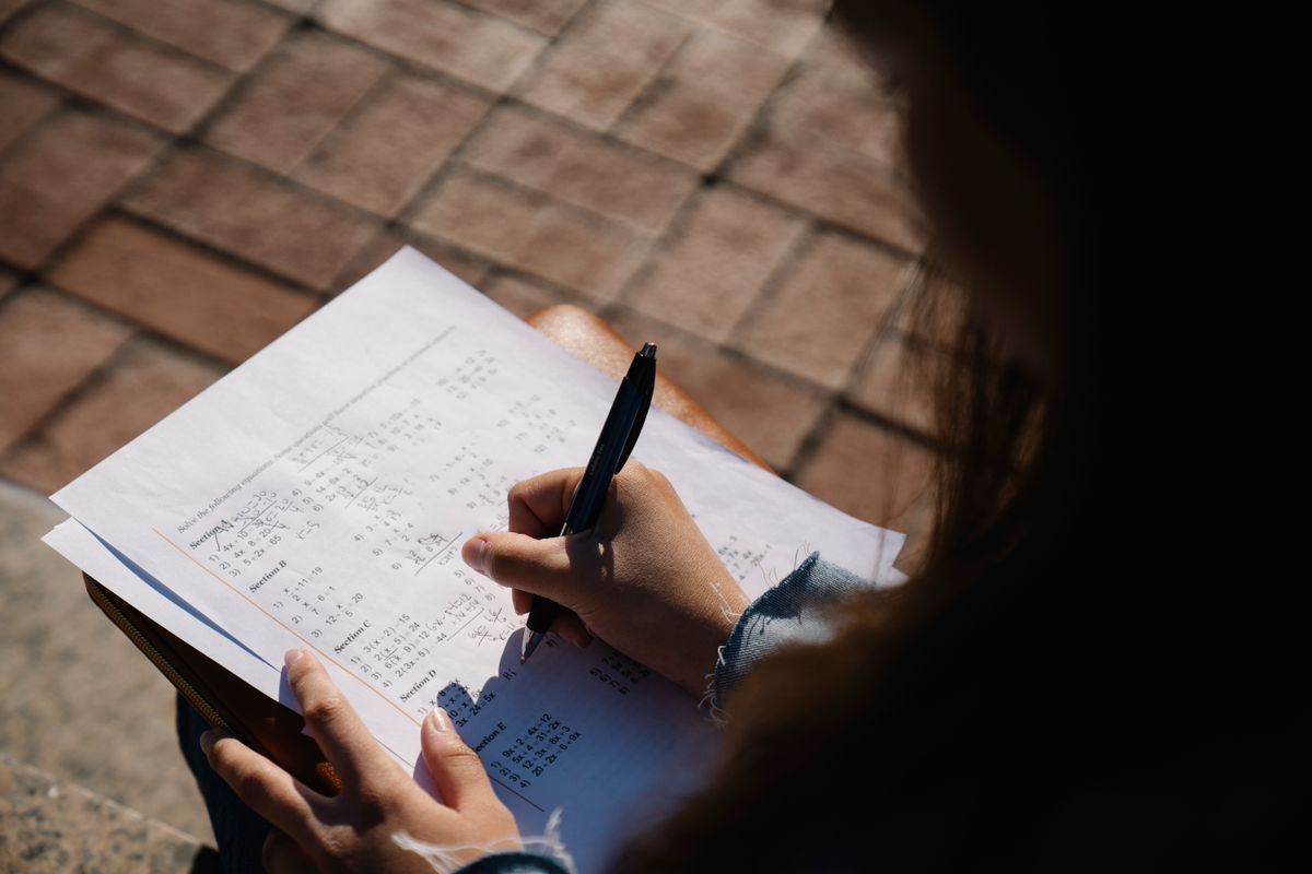 Math worksheet with handwritten calculations for decimal and percent conversion