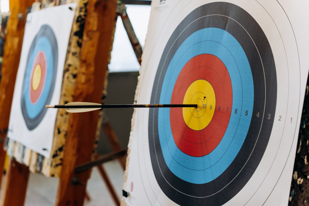 Arrow hitting the bullseye to represent reaching a goal or target